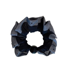 Polka dot pleated scrunchie in grey and black fabric with a sleek black bead detail
