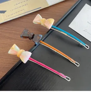 Close-up of a three-piece acetate bow hair clip set with elegant tortoiseshell patterns