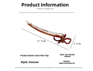 Detailed view of tortoiseshell bow hair clip measuring 11.7cm long with weight details