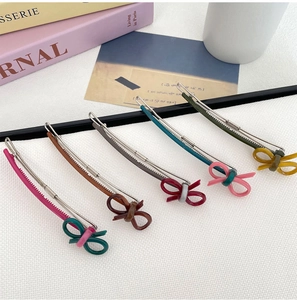 Detailed set of five vintage resin bow hair clips with colorful finishes and alloy base