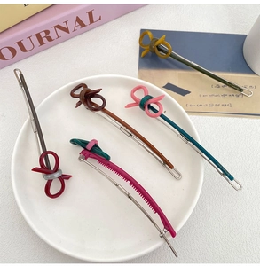 Detailed close-up of colorful acetate bow hair clips on a white display plate