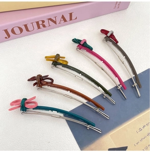 Detailed view of five macaron colored bow hair clips with anti-slip metal grip structure