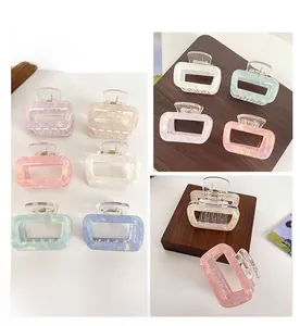 Detailed view of square iridescent hair claws in pastel colors with pearlescent finish