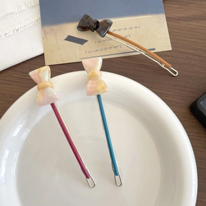 Three elegant marble textured bow hair clips in pink and tortoise shell resin patterns