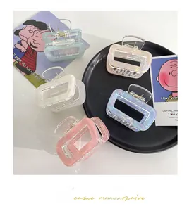 Detail of 5 rectangular acetate hair claws with marble texture in various pastel colors