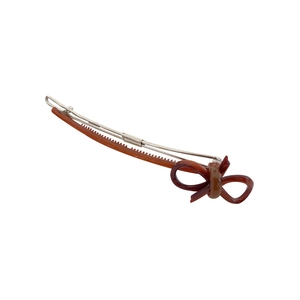 Vintage brown resin bow hair clip with silver metal base shown on a clean white background