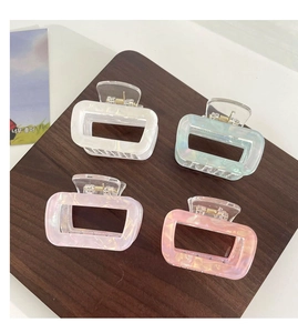 Detail view of 4-piece rectangular acetate hair claws with pearlescent finish