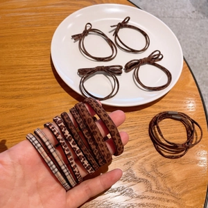 Close-up of leopard and plaid bow hair ties with elastic cords in brown tones