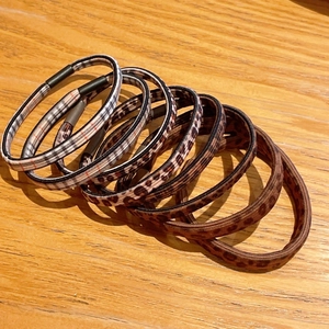Detail view of high-elasticity hair ties in leopard print and classic checkered patterns
