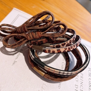 Detail of leopard print bow hair ties and elastic scrunchies in warm brown tones