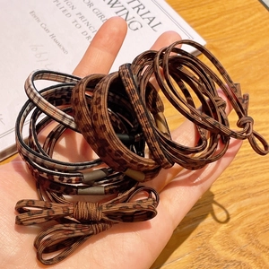 Detailed view of elastic hair ties featuring leopard print and various patterns