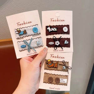Close-up of cute plush hair clips with heart and bow details on display cards