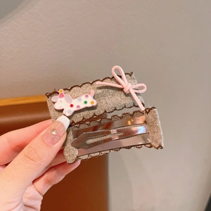 Detail of handmade fabric BB clip with cartoon dachshund and pink bow for children