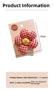 Detail of red plaid fabric sunflower hair clip with yellow center button on a display card
