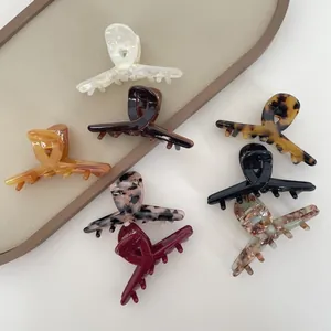 Collection of assorted acetate hair claws in various marble colors and floral patterns