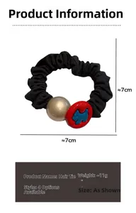 Detail view of black scrunchie showing gold bead and dog logo charm with 7cm size scale