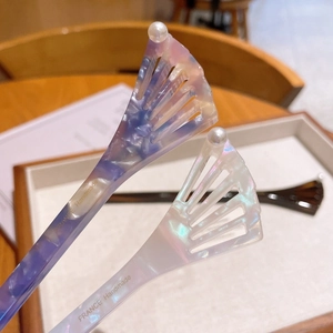 Detail of two acetate hairpins with marble textures and France Handmade engraving