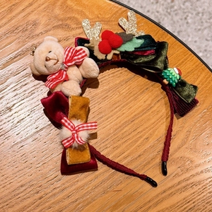 Detail of Christmas headband with plush bear, glitter antlers and velvet bows