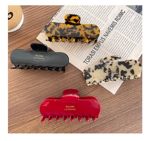 French retro style acetate claw clips in four classic patterns on wooden background