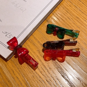 Close-up of handmade acetate bow hair clips in vibrant colors and metallic texture