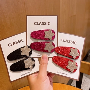 Détail de barrettes à paillettes en noir, rose et rouge sur cartes de présentation