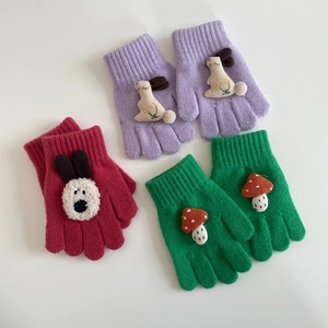 Detail of three pairs of knitted toddler gloves with cute 3D bunny and mushroom patches