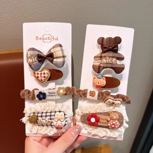 Detailed set of fabric hair clips and ties with plaid bows, teddy bear and lace details