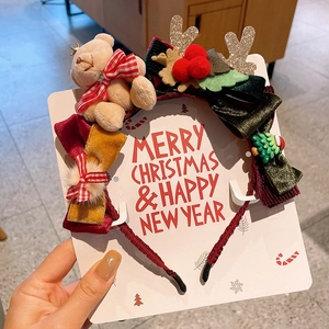 Detailed Christmas headband with velvet bow, cute bear, and antlers on festive card