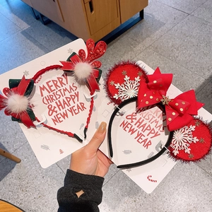 Detail of Christmas reindeer antler headband and snowflake mouse ears with red bow