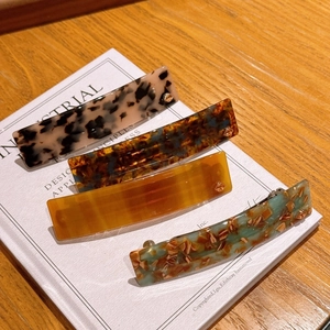 Classic acetate hair clips in tortoiseshell and marble patterns for elegant styling