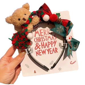 Christmas reindeer antler headband with plush brown bear and festive pinecone accents