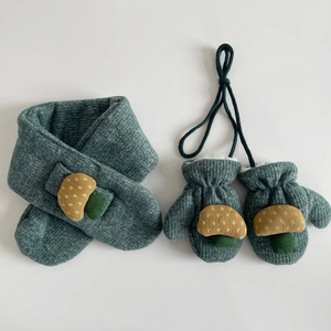 Detail of dark green corduroy scarf and mittens set with mushroom patches and warm fleece lining