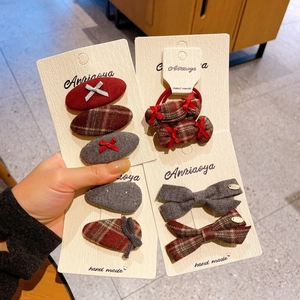 Bow hair clip set with red plaid fabric and velvet ribbon on display card