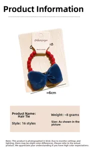 Detail of red wavy elastic hair tie with dark blue velvet bow on cardboard packaging