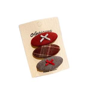 Three-pack Korean fabric bow hair clips in red and plaid wool on display card