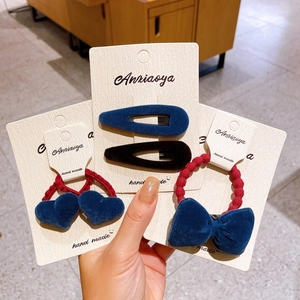 Three-piece velvet hair accessory set with navy blue bows, hearts and hair clips