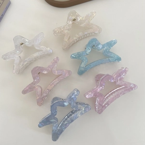 Pack of 6 star-shaped acetate hair claws with marble texture in macaron colors