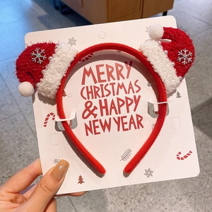 Detail of red plush Christmas headband with mini Santa hats and pearl accents