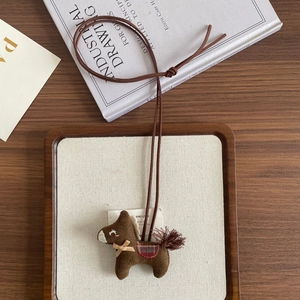 Handmade brown pony plush pendant with red plaid saddle and fringe tail detail