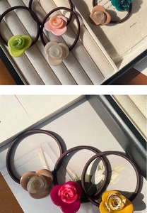 Close-up of elegant acetate rose flower hair ties in multiple colors with high-elastic rope