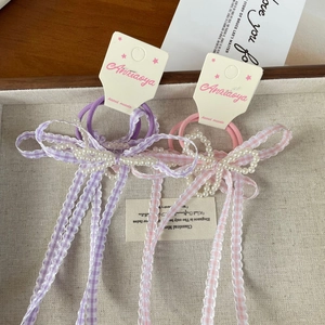 Detailed view of handmade pink and purple plaid lace hair clips with elegant pearl charms