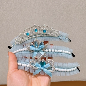 Close-up of light blue lace tiara hairbands with blue rhinestones and pearls