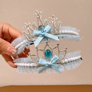 Detail of blue princess hair bun holder with mesh bow, pearls and crown crystal