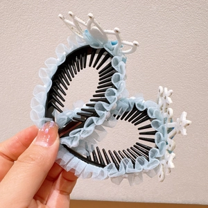Detail of blue tulle hair clips with snowflake and crown accents for girls