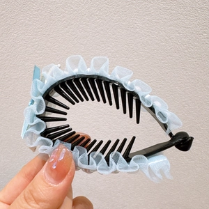 Detail of blue lace trim and bow on hair clip for girls' bun hairstyle