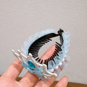 Detailed view of children's blue mesh hair clip with silver crown and blue gemstone
