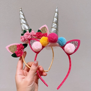 Close-up of unicorn headbands with sequins, felt ears and colorful faux floral details