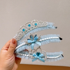 Handheld set of three light blue princess headbands with lace crowns and pearls