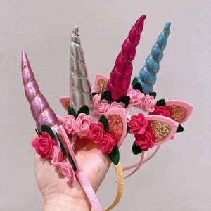 Detailed view of four colorful unicorn flower headbands with glitter ears and roses