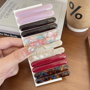 10-piece set of French acetate hair clips in assorted marble patterns on a card